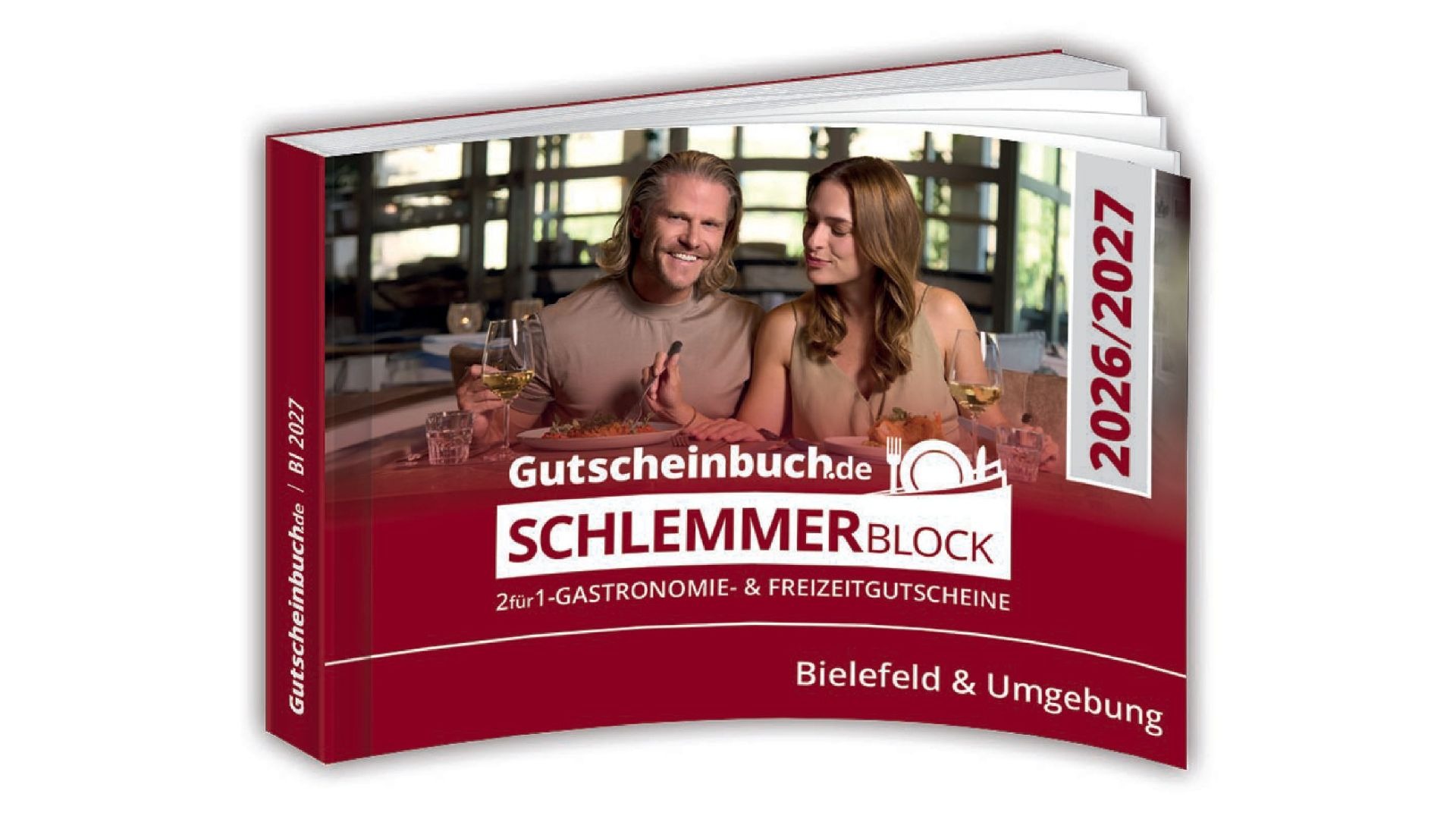 Schlemmerblock-Gutscheinbuch für Bielefeld mit lächelndem Paar, das in einem Restaurant isst und Wein trinkt